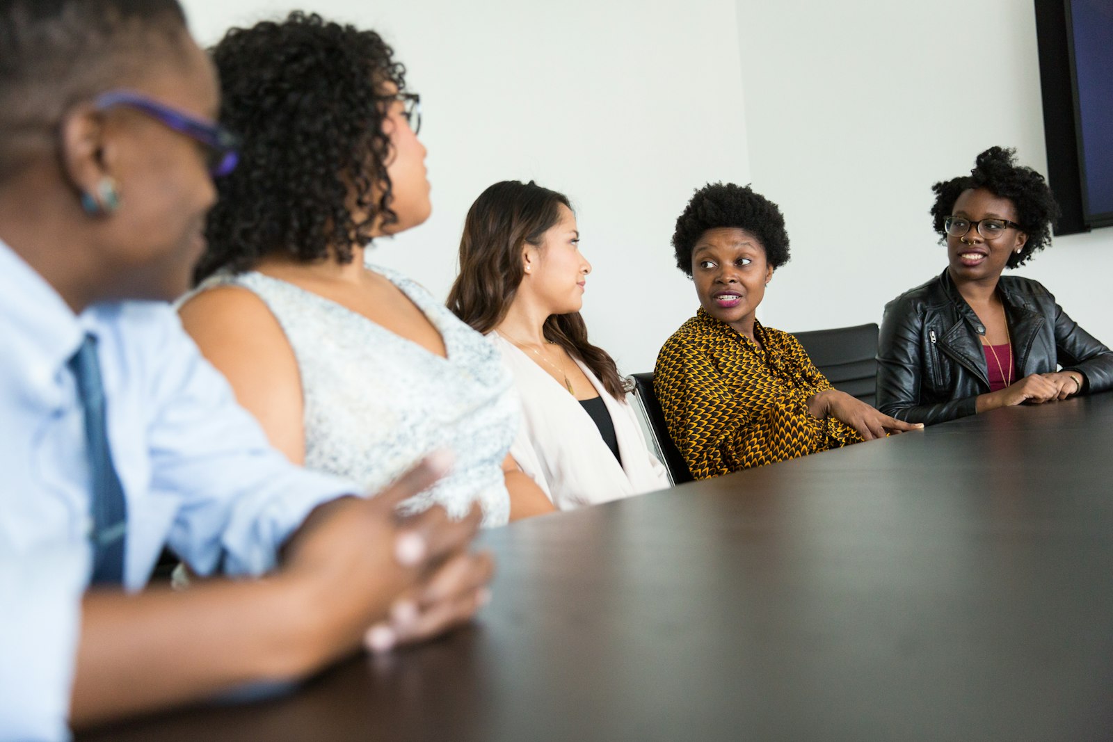 A diverse group in conversation around a table